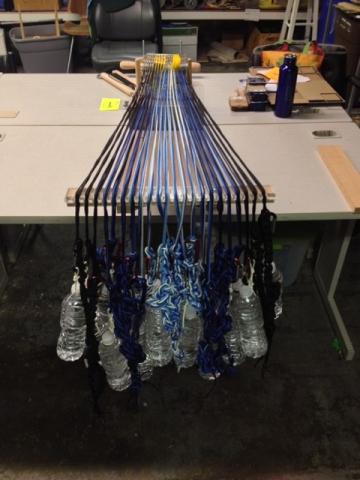 Weighting each card of the loom with water bottles