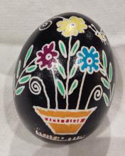 A beginner's egg decorated with many flowers in a vase or pot